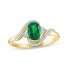 Thumbnail Image 0 of Oval-Cut Lab-Created Emerald & Diamond Bypass Ring 1/15 ct tw 10K Yellow Gold