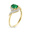 Thumbnail Image 1 of Oval-Cut Lab-Created Emerald & Diamond Bypass Ring 1/15 ct tw 10K Yellow Gold